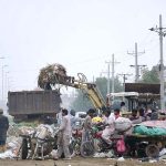Faisalabad Waste Management Company (FWMC) staffers removing offal and remains of sacrificial animal on the 3rd day of Eid ul Azha at Sheikhupura Road