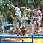 Children enjoying on trampoline at roadside setup