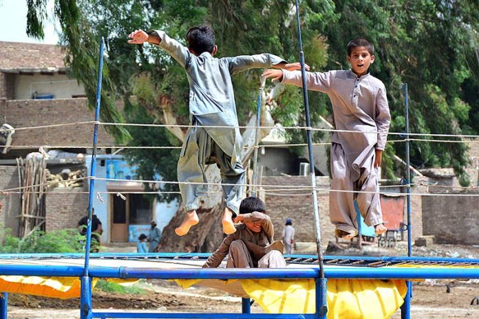 Children enjoying on trampoline at roadside setup
