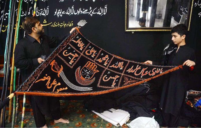 Devotees are preparations for Ashura processions at Agha Mustafa Imambargah