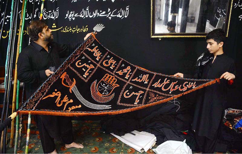 Devotees are preparations for Ashura processions at Agha Mustafa Imambargah