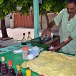 A vendor selling ice gola at his cart