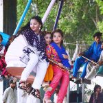 Youngsters enjoying the mechanical swing ride at Fun Land Park