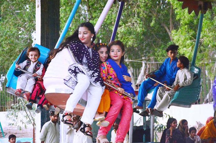 Youngsters enjoying the mechanical swing ride at Fun Land Park