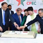 Prime Minister Muhammad Shehbaz Sharif, Chargé d'affaires of the Chinese Embassy in Islamabad Ms. Pang Chunxue and Federal Ministers cutting a cake marking the 10th anniversary of the signing of the agreement for CPEC