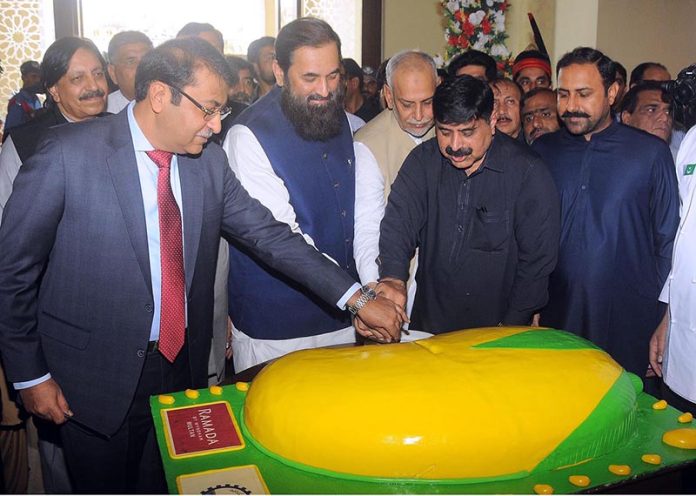 Governor Punjab Engr. Muhammad Baligh Ur Rehman cutting mango cake during the inaugural ceremony of three days ''Mango Festival 2023'' at DHA Arena Hall