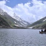 The beautiful view of Lake Saif ul malook with clouds hovering over the mountains