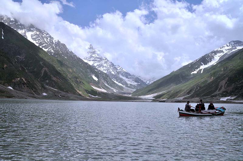 The beautiful view of Lake Saif ul malook with clouds hovering over the mountains