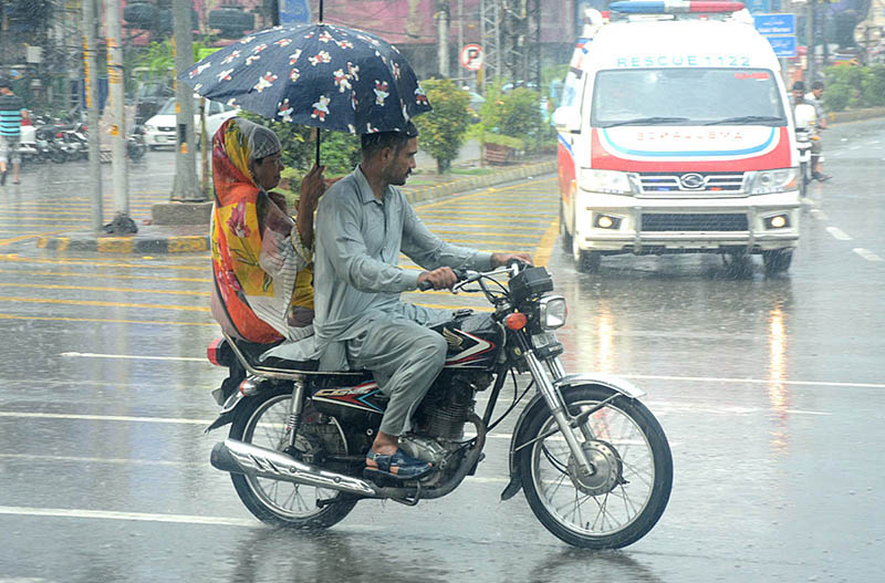 A family traveling during heavy rainfall in the city
