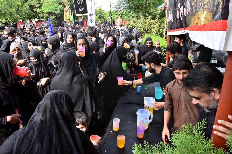 Volunteers serving Sabeel (special drinks) during the main procession of 9th Muharram-ul-Haram observing Youm-e-Ashura at G-6 Road. Muharram ul Harram, the first month of the Islamic calendar is known as the mourning month to pay homage in remembrance of the martyrdom (Shahadat) of Hazrat Imam Hussain (AS), the grandson of the Holy Prophet Mohammad (SAWW), along with his family members and companions at the battle of Karbala