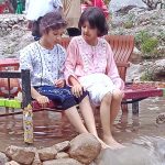 Young girls enjoying in the water at Shahdara valley near outskirts of the Federal Capital