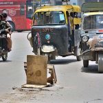 A view of open sewerage manhole covered the wood pieces at Hyder Chowk may cause any mishap and needs the attention of concerned authorities
