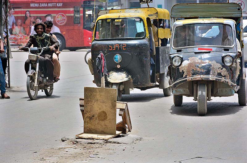 A view of open sewerage manhole covered the wood pieces at Hyder Chowk may cause any mishap and needs the attention of concerned authorities