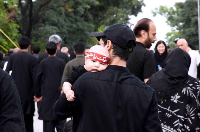 A large number of people attending the main procession of 9th Muharram-ul-Haram observing Youm-e-Ashura at G-6 Road. Muharram ul Harram, the first month of the Islamic calendar is known as the mourning month to pay homage in remembrance of the martyrdom (Shahadat) of Hazrat Imam Hussain (AS), the grandson of the Holy Prophet Mohammad (SAWW), along with his family members and companions at the battle of Karbala