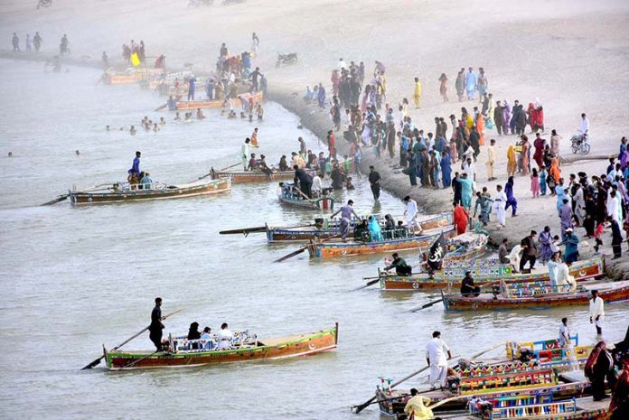 A large number of visitors enjoying boat riding at Almanzar Picnic Point at River Indus on the 3nd day of Eid-ul-Adha celebrations