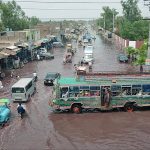 Vehicle drivers facing difficulties while passing through stagnant rain water accumulated at Nishatabad after heavy rain in the city