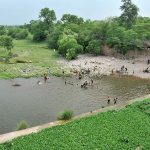 Youngsters jumping and bathing in water channel of Rawal Dam to get some relief from hot weather in Federal Capital