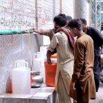 People fill their pots with clean drinking water from water tap.