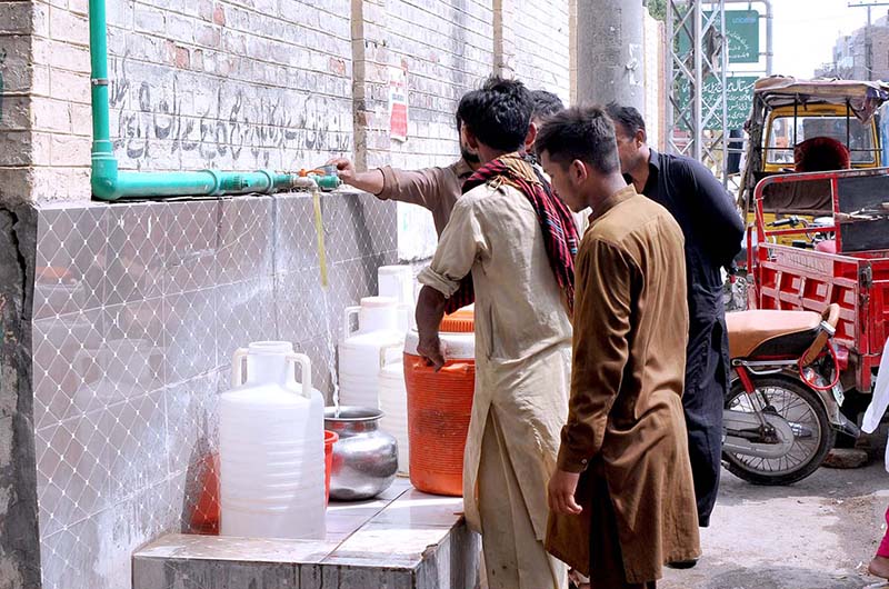 People fill their pots with clean drinking water from water tap.