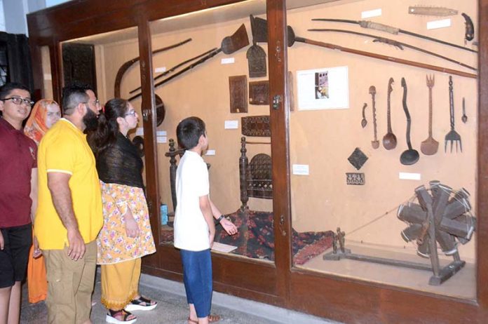 Visitors viewing displayed artworks at Lahore Museum
