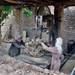 Laborers cutting woods at their roadside setup
