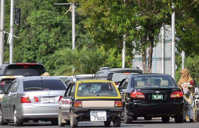 A woman bagger asking for some mercy from vehicle drivers in Federal Capital A woman bagger asking for some mercy from vehicle drivers in Federal Capital