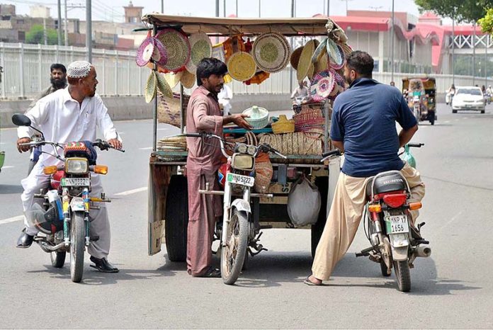 Customers purchasing traditional handmade items from roadside vendor
