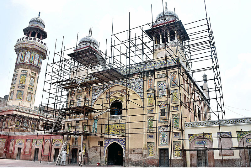 Labourers renovation work at historical Mosque Masjid Wazir Khan at Walled. The Wazir Khan Mosque is 17th century. The mosque was commissioned during the reign of the Mughal Emperor Shah Jahan as part of an ensemble of buildings that also included the nearby Shahi Hammam baths. Construction of Wazir Khan Mosque began in 1634 C.E., and was completed in 1641