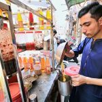 A vendor preparing traditional summer drink “gond katira” to attract the customers at Namak Mandi area