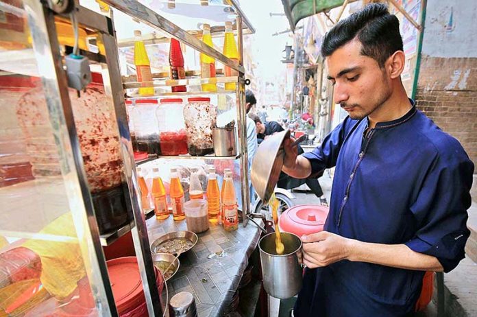 A vendor preparing traditional summer drink “gond katira” to attract the customers at Namak Mandi area A vendor preparing traditional summer drink “gond katira” to attract the customers at Namak Mandi area