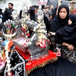 Mourners touch Tazia during the main procession of 9th Muharram-ul-Haram observing Youm-e-Ashur at M.A Jinnah Road. Muharram ul Harram, the first month of the Islamic calendar is known as the mourning month to pay homage in remembrance of the martyrdom (Shahadat) of Hazrat Imam Hussain (AS), the grandson of the Holy Prophet Mohammad (SAWW), along with his family members and companions at the battle of Karbala.