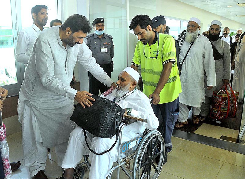 Pilgrims coming out from the airport as First Hajj flight landed after performing Hajj at Multan International Airport