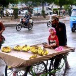 People passing on the road during a view of light to moderate rain in the Metropolis
