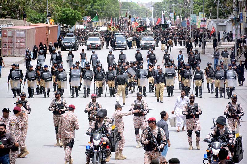 Security personnel high alert during the 10th Muharram procession to mark Ashoura at M.A Jinnah Road. Ashoura is the commemoration marking the Shahadat (death) of Hussein (AS), the grandson of the Prophet Muhammad (PBUH), with his family members during the battle of Karbala for the upright of Islam