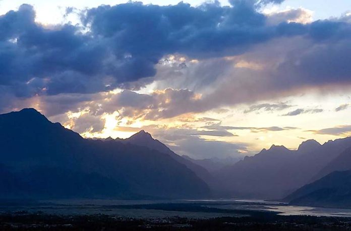 An eye catching view of sunset over the mountain along with river Indus