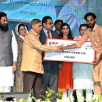 Prime Minister Muhammad Shehbaz Sharif distributing cheques among the recipients of Prime Minister's Youth Business and Agriculture Loan Scheme
