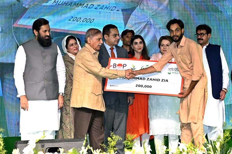 Prime Minister Muhammad Shehbaz Sharif distributing cheques among the recipients of Prime Minister's Youth Business and Agriculture Loan Scheme
