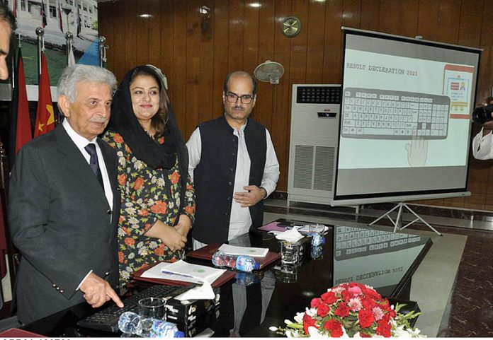 Federal Minister for Education & Professional Training Rana Tanveer Hussain is pressing the key of computer to confirm during the Result Declaration ceremony SSC Part I & II 1st Annual Exam 2023 at FBISE