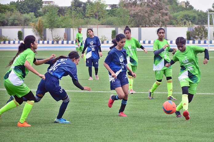 Females players of Sukkar and Larkana Football Teams are in action during Prime Ministers Talent Hunt Youth Sports League at Public School Ground