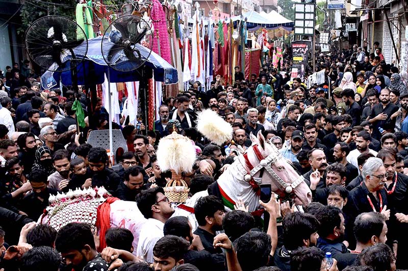 Mourners touch Tazia during the main procession of 9th Muharram-ul-Haram observing Youm-e-Ashur at M.A Jinnah Road. Muharram ul Harram, the first month of the Islamic calendar is known as the mourning month to pay homage in remembrance of the martyrdom (Shahadat) of Hazrat Imam Hussain (AS), the grandson of the Holy Prophet Mohammad (SAWW), along with his family members and companions at the battle of Karbala