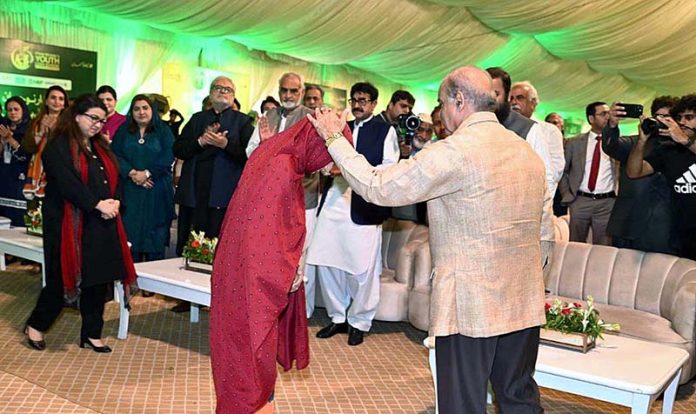 Prime Minister Muhammad Shehbaz Sharif distributing cheques among the recipients of Prime Minister's Youth Business and Agriculture Loan Scheme