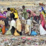 A large numbers of gypsy women with children searching valuable items from garbage at Latifabad.