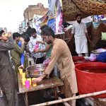 People drinking Sabeel (special drink) offer by volunteers along the roadside in connection of Ashura at Sher Kathi Bazar