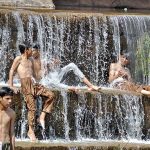 Youngsters jumping and bathing in the water channel of Rawal Dam to get some relief from hot weather in Federal Capital