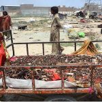 A gypsy family hanging sacrificial animal meat for drying in Ring Road Gypsy Camp