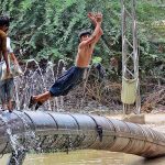 Youngsters enjoy jumping and bathing in the channel Mori Canal to get relief from scorching hot weather