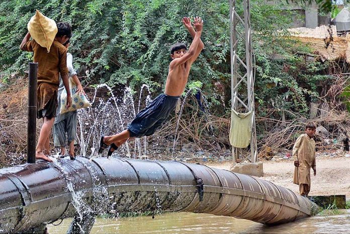 Youngsters enjoy jumping and bathing in the channel Mori Canal to get relief from scorching hot weather