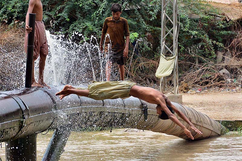 Youngsters enjoy jumping and bathing in the channel Mori Canal to get relief from scorching hot weather