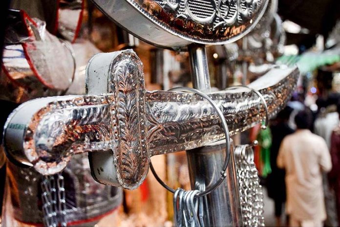 Shopkeeper displays Muharram-ul-Harram related stuff to attract the customer at Bibi Pak Daman
