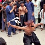 Mourners flagellate themselves with knifes on chains during the 10th Muharram procession to mark Ashoura. Ashoura is the commemoration marking the Shahadat (death) of Hussein (AS), the grandson of the Prophet Muhammad (PBUH), with his family members during the battle of Karbala for the upright of Islam
